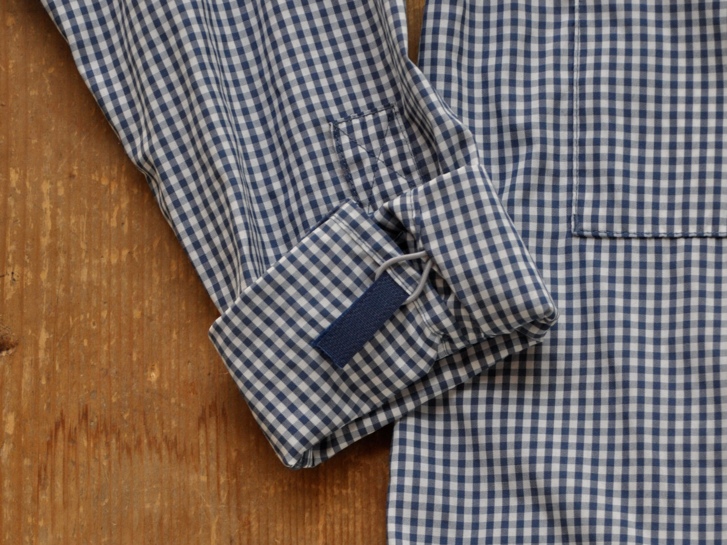 white and navy gingham shirt sleeves in detail