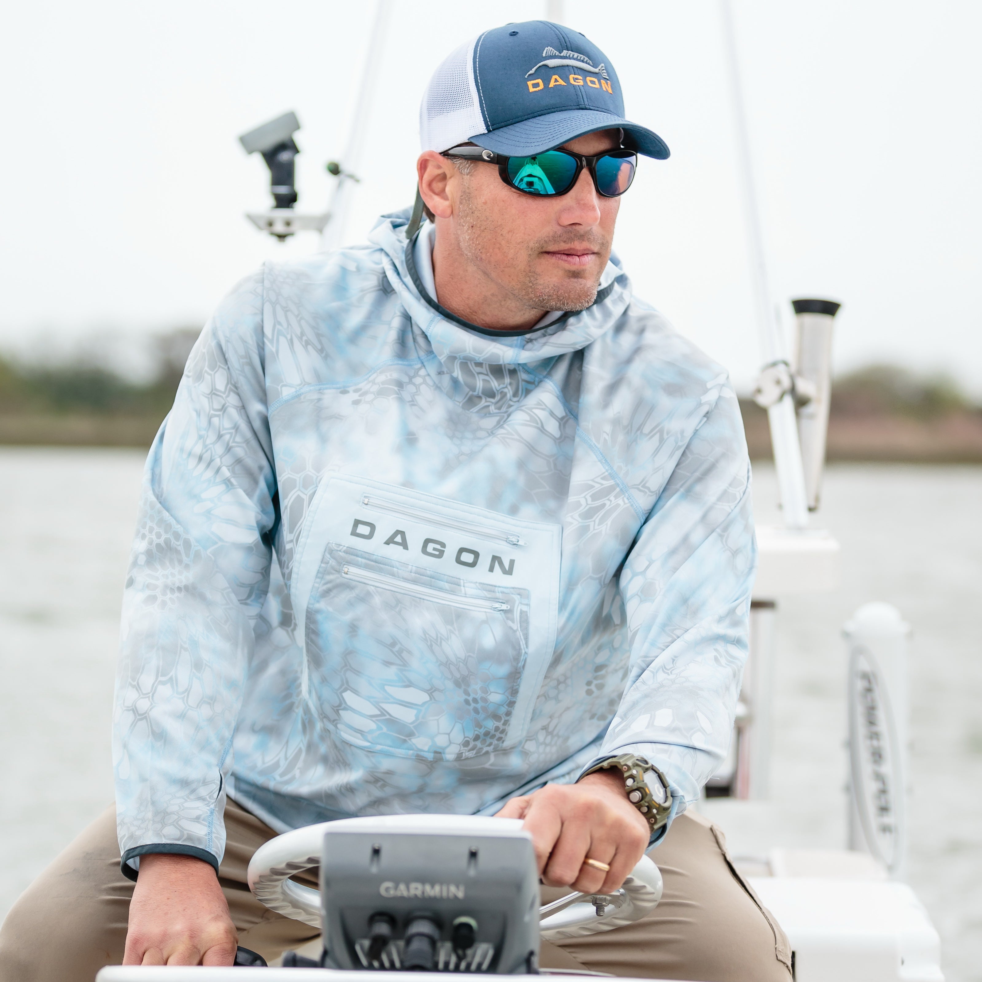 man on Driving boat with kryptek power hoodie
