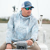man on Driving boat with kryptek power hoodie