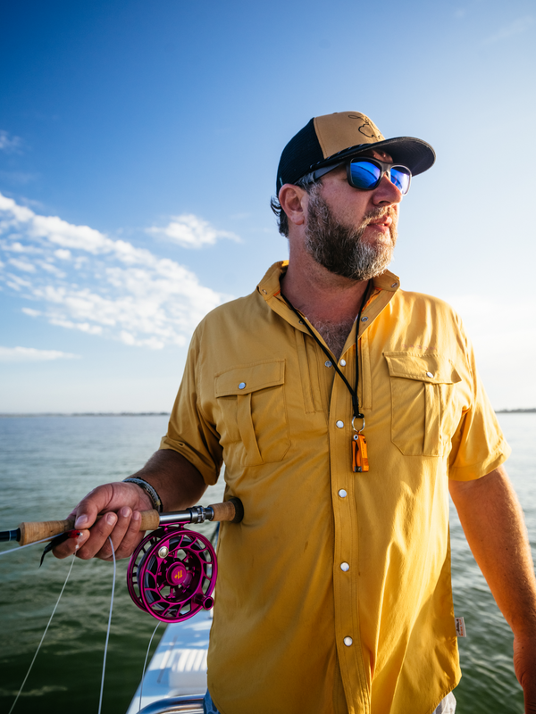 Angler wearing Dagon's sunflower khaki shirt on fishing