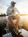 Man wearing dagon's honeydew hoodie and field green shorts on fishing.