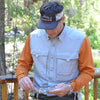 a seasoned angler in proper fishing attire, cleaning his fishing equipment.