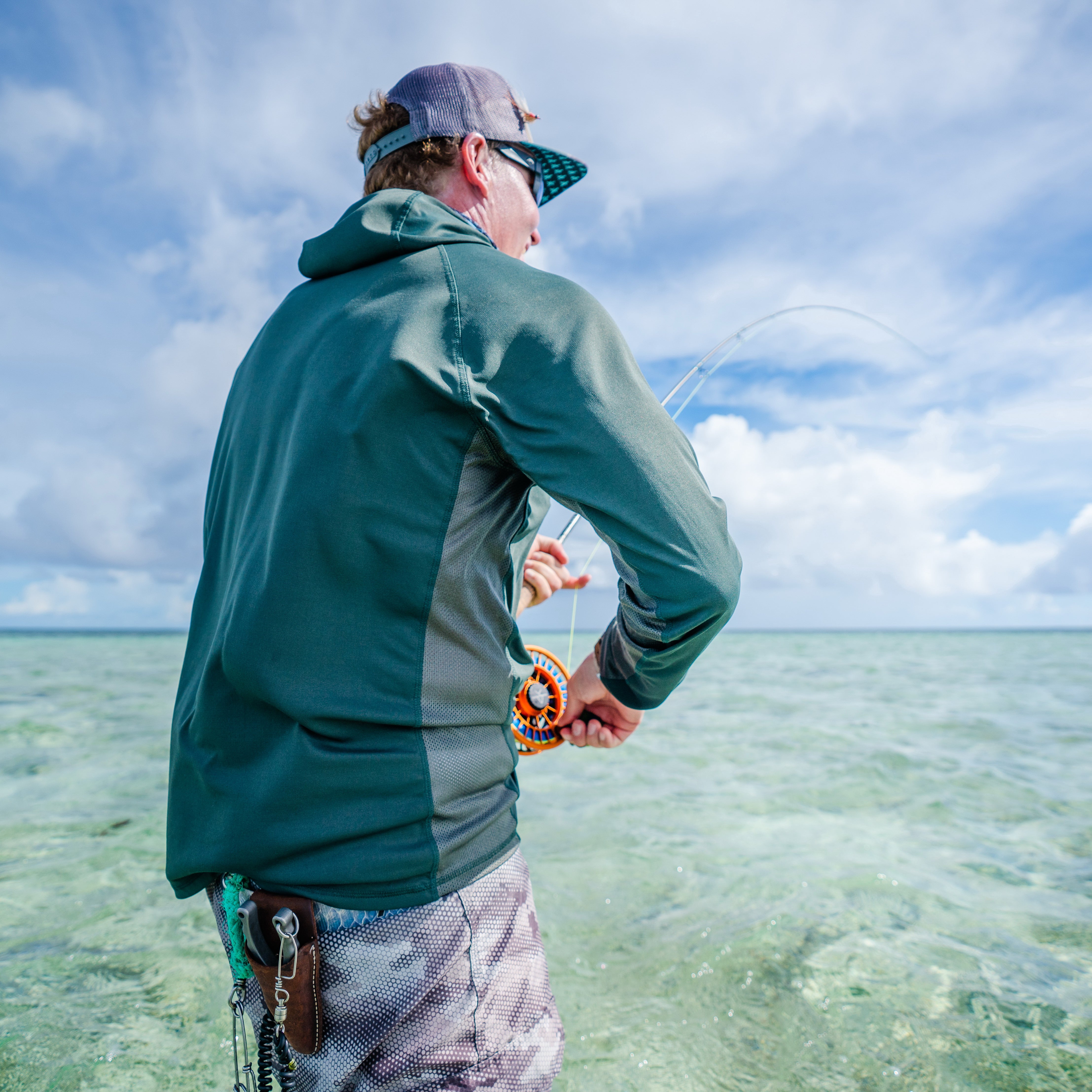 Man casting while wearing dagon's hunter green hoodie