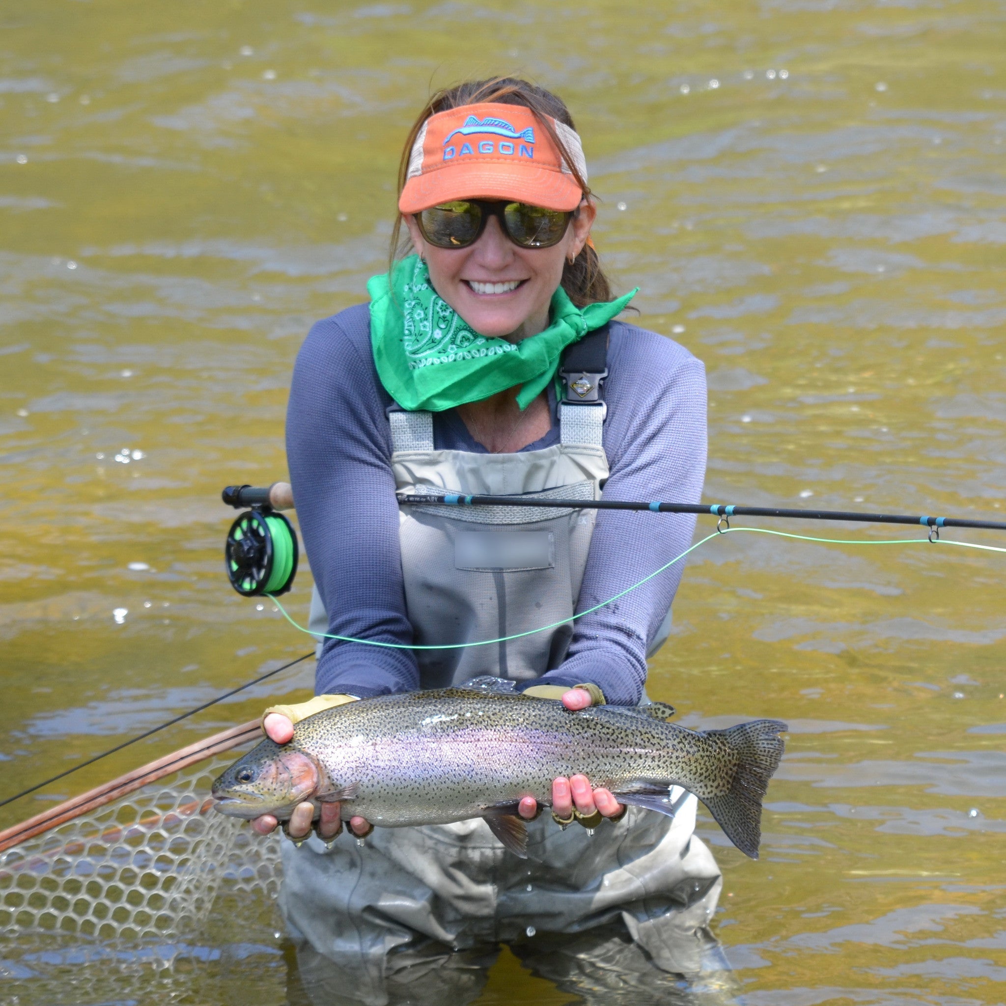 a seasoned female angler wear Dagon orange mesh back visor on fly fishing.
