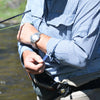 Man rolling up sleeves of Navy Gingham Shirt