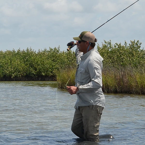 Man wearing Dagon Cloud Gray shirt on fly fishing
