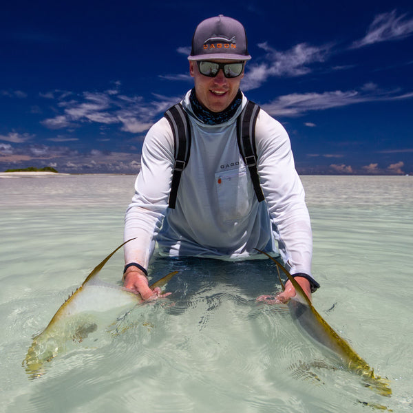 Man wearing skyway hoodie and flat bill hat on fly fishing