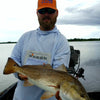 Man posing with showing his catch while wearing Dagon hoodie