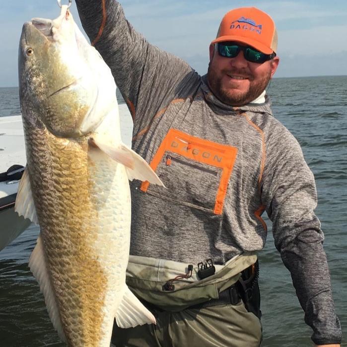 A person wearing dagon apparel showing fish.