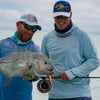 2 anglers wearing ocean blur hoodie by Dagon apparel are celebrating their gigantic catch