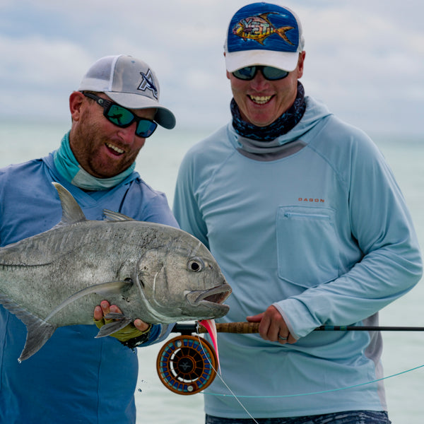 2 anglers wearing ocean blur hoodie by Dagon apparel are celebrating their gigantic catch