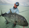 A seasoned angler wearing ocean blue hoodie on fly fishing and catch a big one.