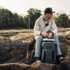Angler with all equipment and wearing complete fishing apparel