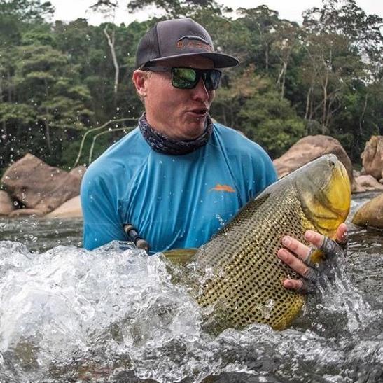 Angler wearing blue wave sunshirt for fly fishing